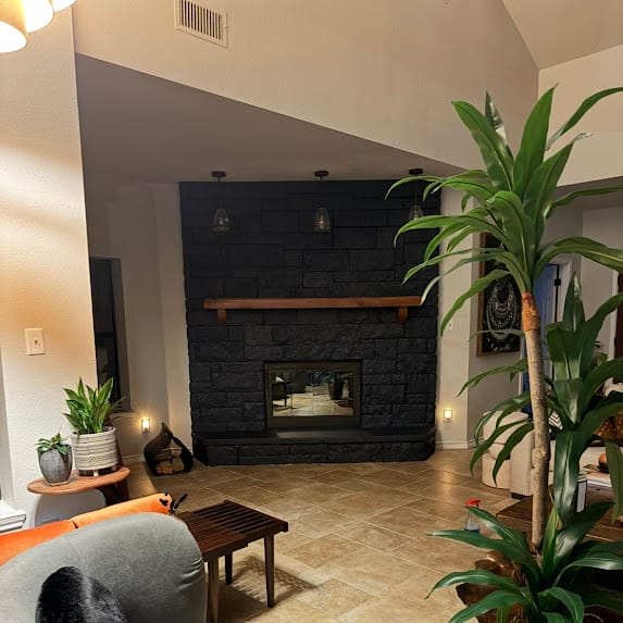 Completed residential fireplace with a modern stone surround
