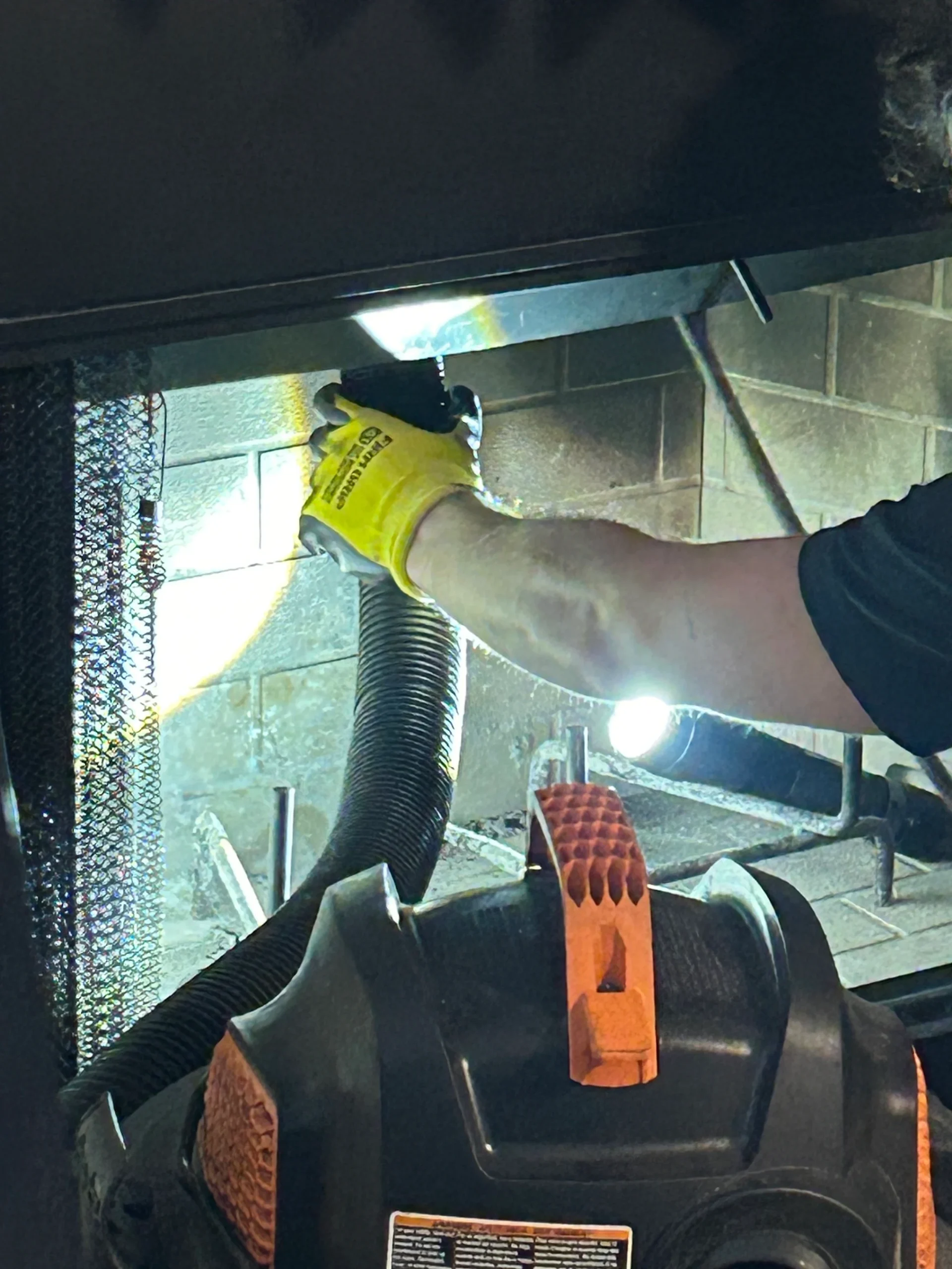Santa Chimney Sweep technician cleaning a residential fireplace