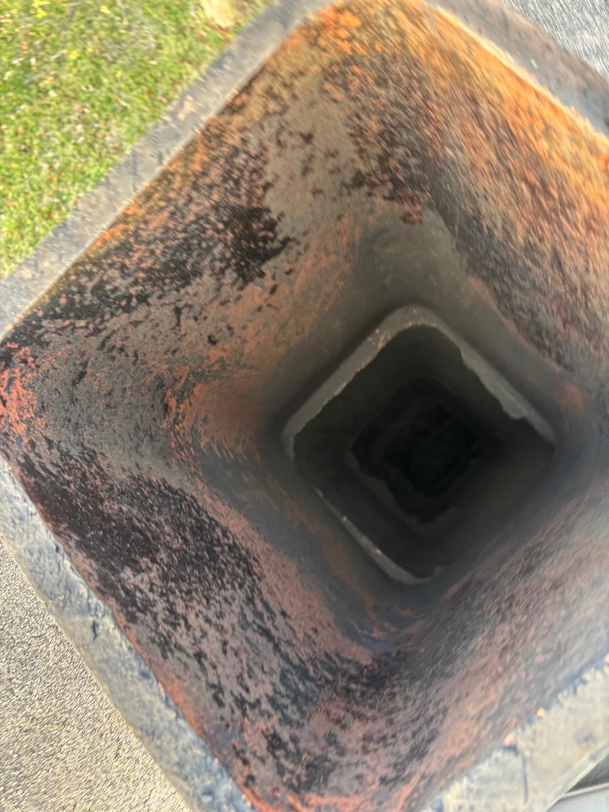 Interior view of a residential chimney flue showing visible buildup