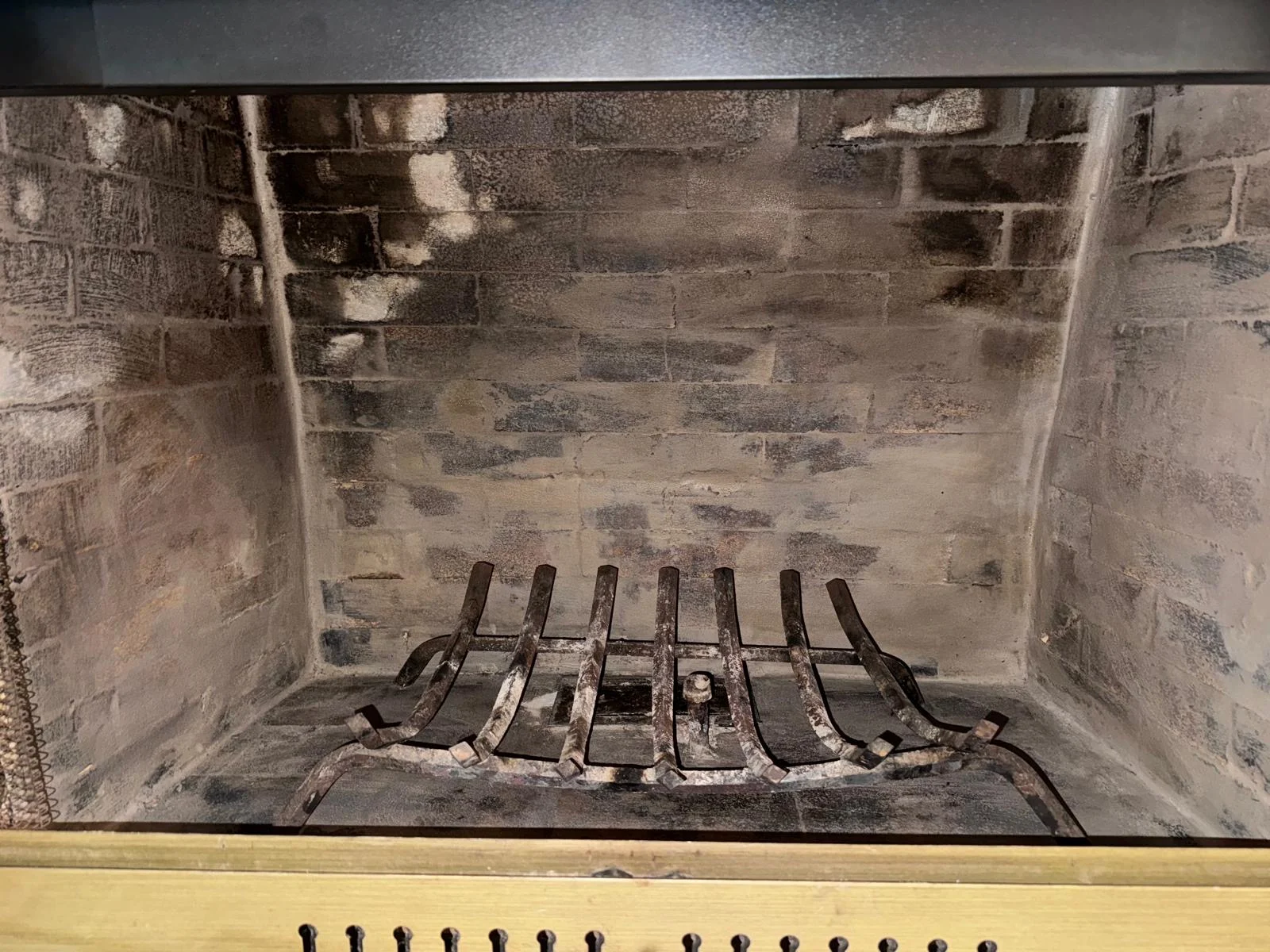 Residential firebox showing ash, soot, and visible residue before cleaning